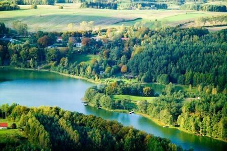 Gmina Linia z lotu ptaka: błękitne jezioro i zielone, gęste lasy.