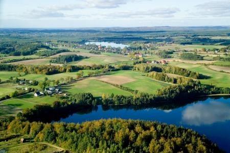 Widok z lotu ptaka na zielone lasy, pola i jeziora Gminy Linia.