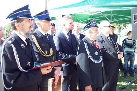 Uroczystość wręczenia sztandaru dla OSP Lewino z udziałem strażaków w galowych mundurach.