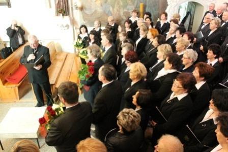 Wiele osób w ciemnych strojach na uroczystości requiem.