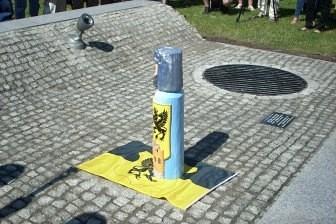 Uczestnicy Zjazdu Kaszubów na ulicy we Władysławowie, widoczny pachołek ostrzegawczy.