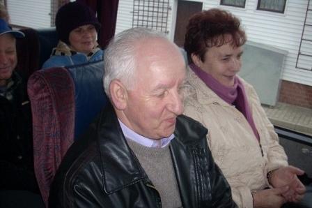 Uczestnicy targów ogrodniczych siedzą w sali, w centrum starszy pan z siwymi włosami.