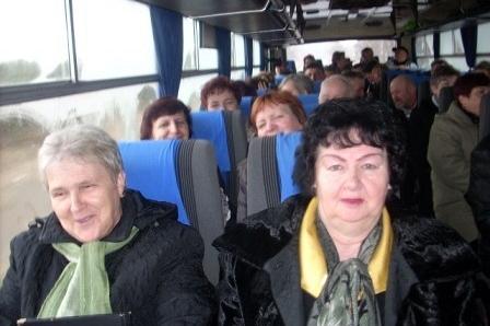 Grupa osób, głównie kobiet, podróżuje autobusem na Dzień Jedności Kaszubów w Słupsku.