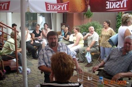 Członkowie Zrzeszenia Kaszubsko-Pomorskiego siedzą razem pod parasolami.