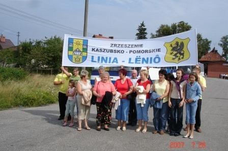 Uczestnicy Zjazdu Kaszubów pozują z banerem Gmina Linia - Lębork.