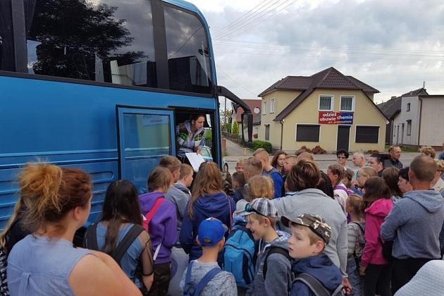 Uczestnicy kolonii językowej w Karpaczu przy niebieskim autokarze.